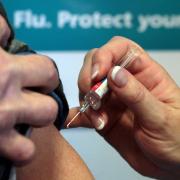 'Community champions' are welcoming people to an outreach event where they can learn more about vaccinations in Reading. Credit: David Cheskin/PA Wire.