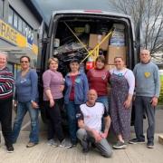 Ronnie Goodberry, centre, and other volunteers in front of the first van full of donations headed for Ukraine earlier this year