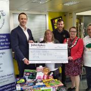 Left to right: John Sykes, founder of the John Sykes Foundation, presents a cheque to Laura Windisch, Toys and Teens project manager, with Karl Nixon of sponsor Big Yellow, Reading Deputy Mayor Debs Edwards and volunteer Ruth Perkins