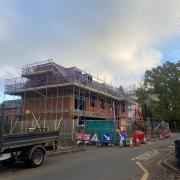 Construction well underway to build retail space and four apartments on a grassy patch next to 114-116 School Road in Tilehurst. Credit: UGC