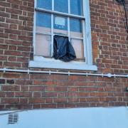 The missing window panel secured by a bin bag at the home near Reading town centre. Credit: Rochelle Bennett