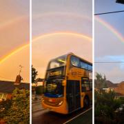 Reading family share pictures of double rainbow above town