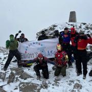 Group dressed as superheroes climbs mountain in blizzard for son who died of cancer