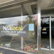 Adverts for the new Nisa at the former Just Tiles shop in Woodley