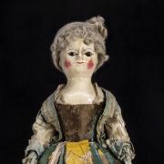 18th century doll wearing a petticoat made from a newspaper article about the brutal murder of a maid has sold for £27,500