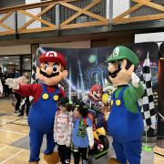 Mario and Luigi posed with children