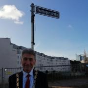 Councillor Tony Page, the Mayor of Reading, next to the newly named Readinger Strasse in Dusseldorf, Germany. Credit: The Mayor of Reading
