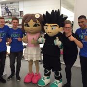 The Retail Trust's mascots alongside some of the members they have supported.