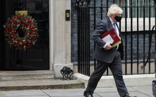 Prime Minister Boris Johnson leaves 10 Downing Street, London, to attend Prime Minister's Questions at the Houses of Parliament. Picture date: Wednesday December 15, 2021. Credit: PA