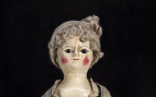 18th century doll wearing a petticoat made from a newspaper article about the brutal murder of a maid has sold for £27,500