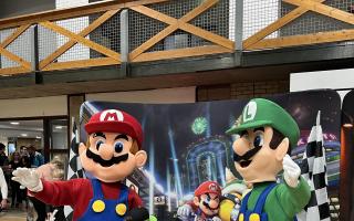 Mario and Luigi posed with children